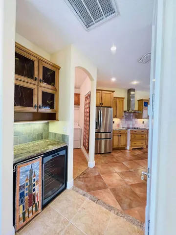 a bathroom with a granite countertop tub sink and mirror