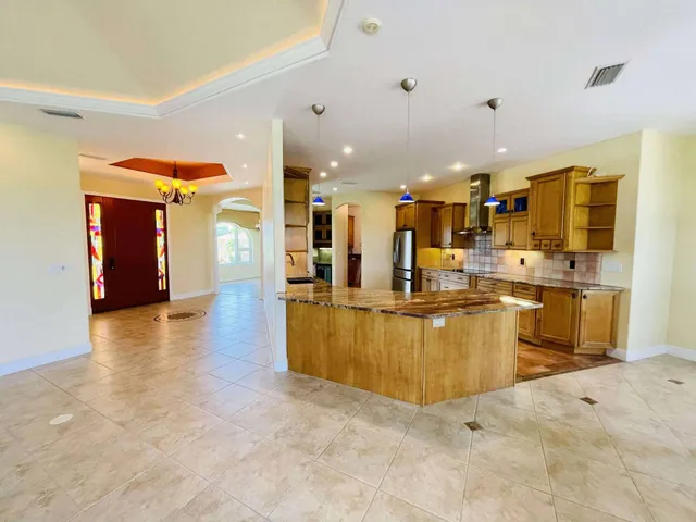 a dining room with furniture a chandelier and window