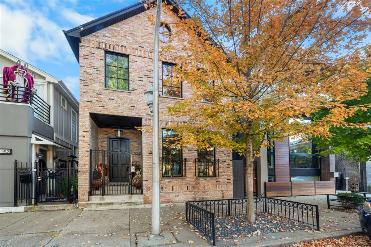 Undisclosed Address Chicago, IL 60622 - Photo 2 of 41 a view of a brick house with large windows and a table and chairs
