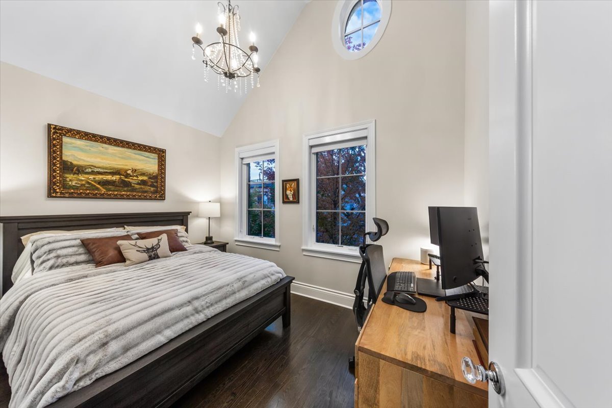 Undisclosed Address Chicago, IL 60622 - Photo 21 of 41 a bedroom with a bed and a chandelier