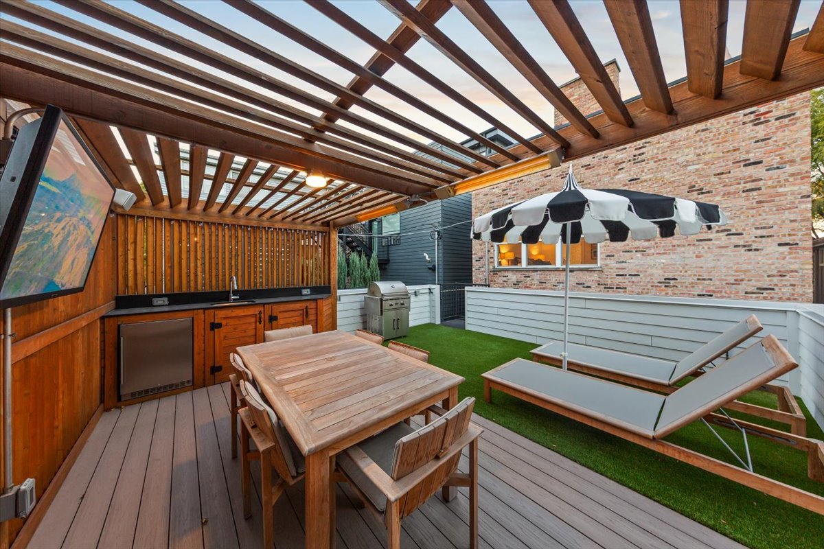 Undisclosed Address Chicago, IL 60622 - Photo 41 of 41 a roof deck with a dining table and chairs with wooden floor