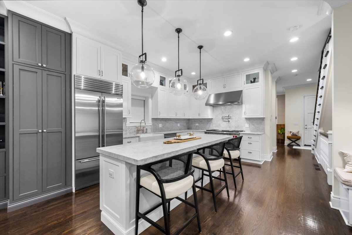 Undisclosed Address Chicago, IL 60622 - Photo 5 of 41 a kitchen with stainless steel appliances granite countertop a table chairs stove and refrigerator