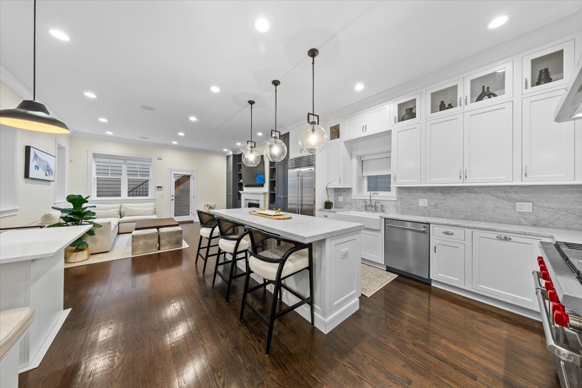 Undisclosed Address Chicago, IL 60622 - Photo 7 of 41 a kitchen with stainless steel appliances granite countertop a stove top oven a sink dishwasher and a dining table with wooden floor