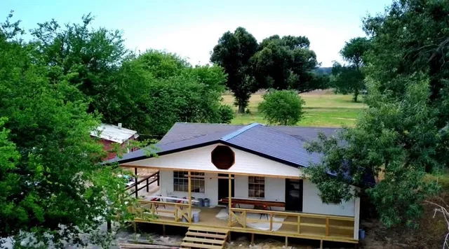 an aerial view of house with yard and outdoor seating