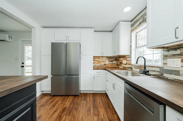 a kitchen with a sink a refrigerator and a sink