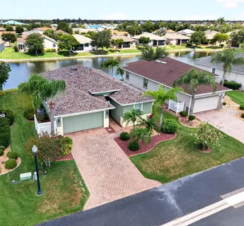an aerial view of a house with a lake view