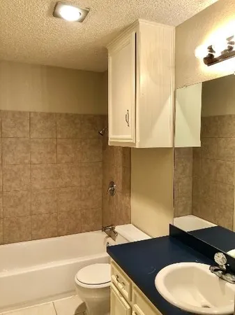 a bathroom with a sink a toilet and bathtub