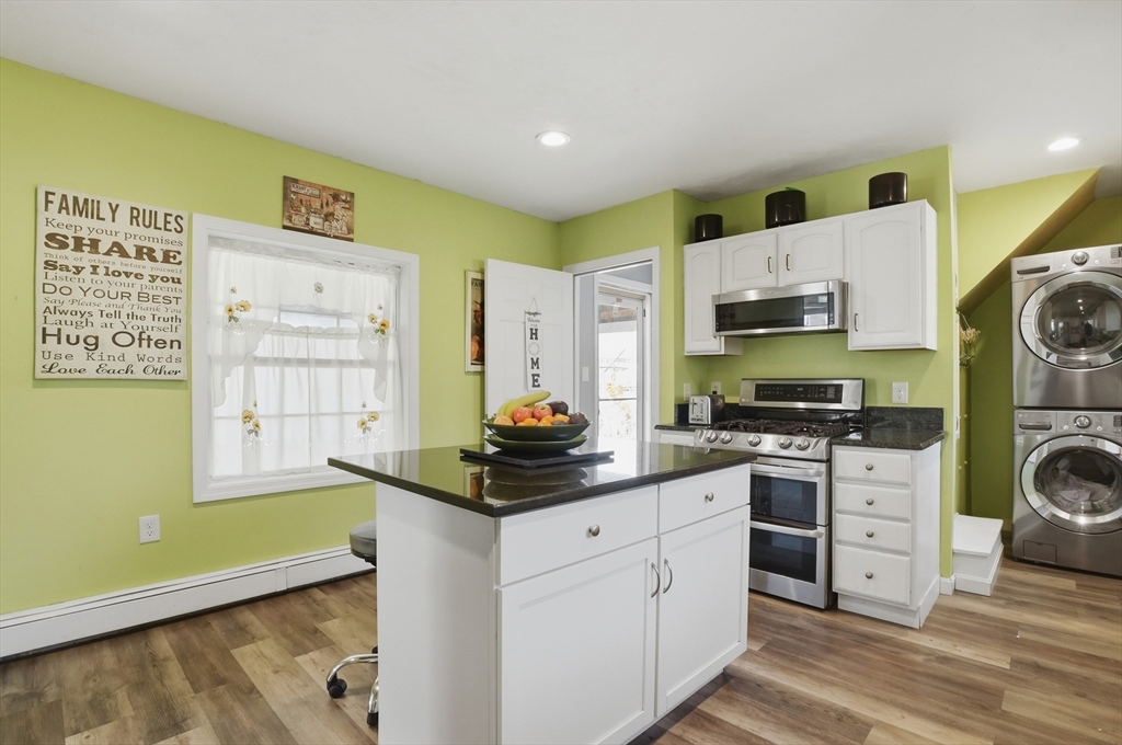 59 Cottage Street Franklin, MA 02038 - Photo 11 of 42 a kitchen with stainless steel appliances a stove a sink and a refrigerator