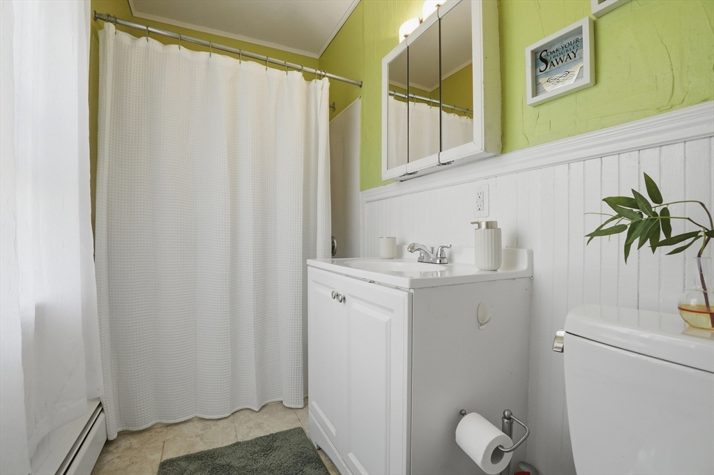 59 Cottage Street Franklin, MA 02038 - Photo 20 of 42 a bathroom with a sink and a shower curtain