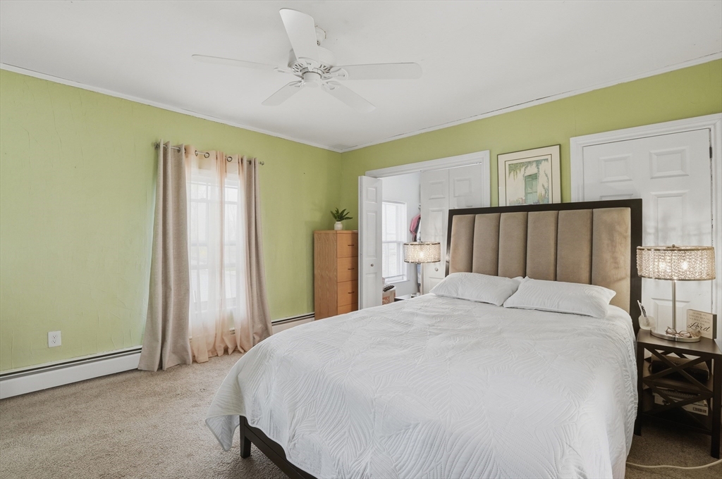59 Cottage Street Franklin, MA 02038 - Photo 23 of 42 a bedroom with a bed and a chandelier