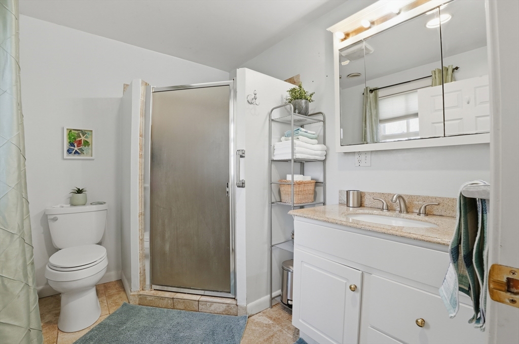 59 Cottage Street Franklin, MA 02038 - Photo 24 of 42 a bathroom with a granite countertop sink toilet and shower