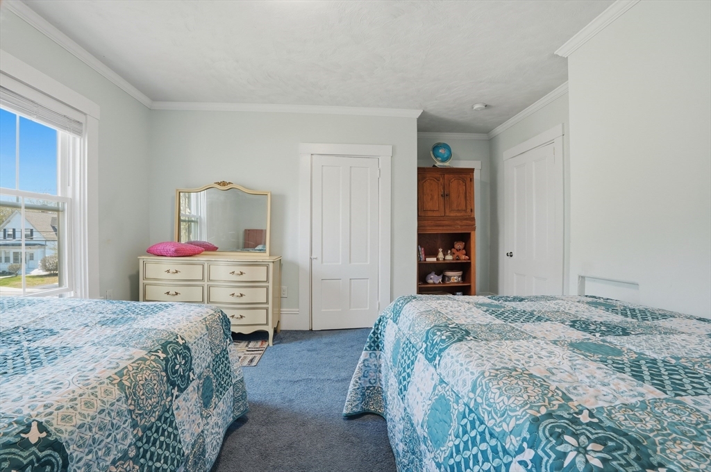 59 Cottage Street Franklin, MA 02038 - Photo 26 of 42 a bedroom with a bed and a flat screen tv
