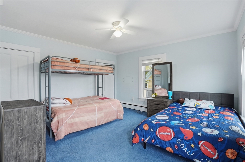 59 Cottage Street Franklin, MA 02038 - Photo 28 of 42 a bedroom with two beds and a chandelier