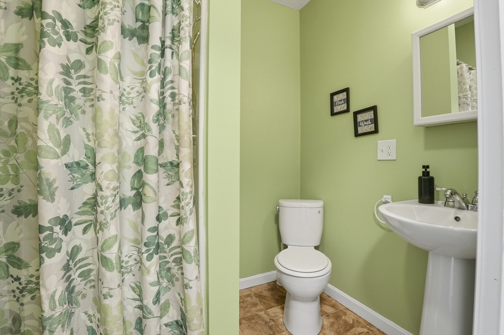 59 Cottage Street Franklin, MA 02038 - Photo 30 of 42 a bathroom with a toilet a sink and a shower