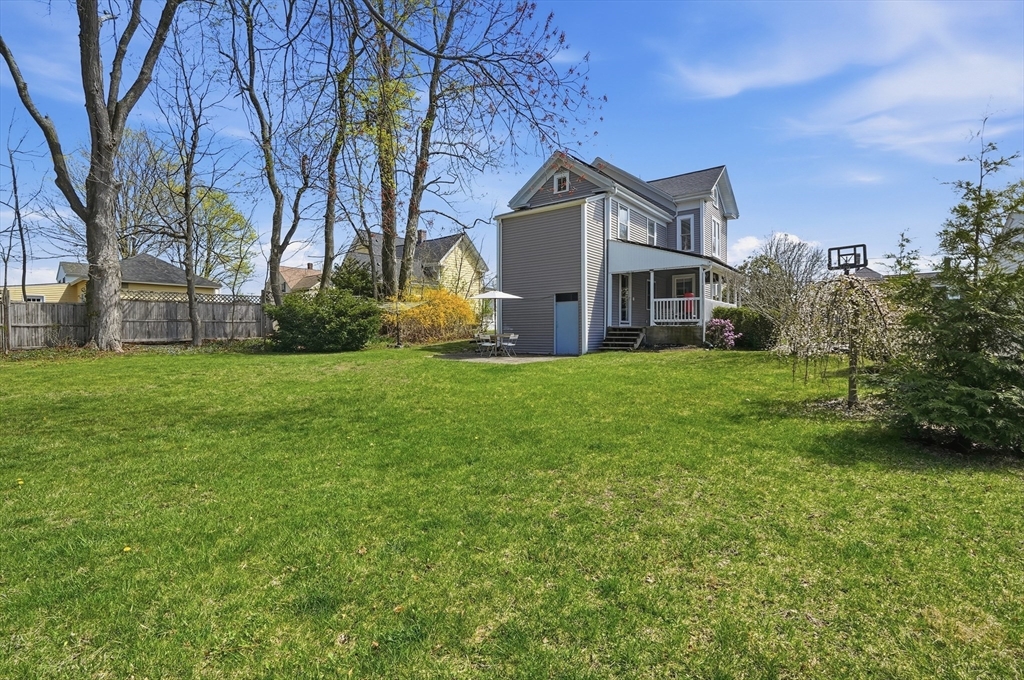 59 Cottage Street Franklin, MA 02038 - Photo 40 of 42 a front view of a house with a garden and trees