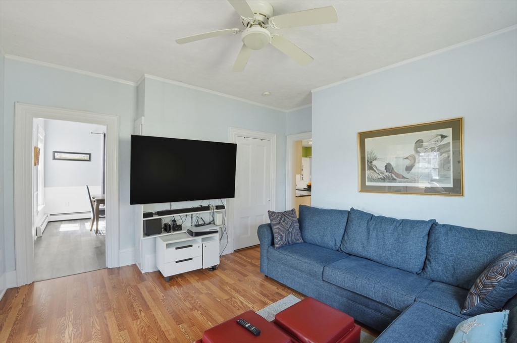 59 Cottage Street Franklin, MA 02038 - Photo 7 of 42 a living room with furniture and a flat screen tv