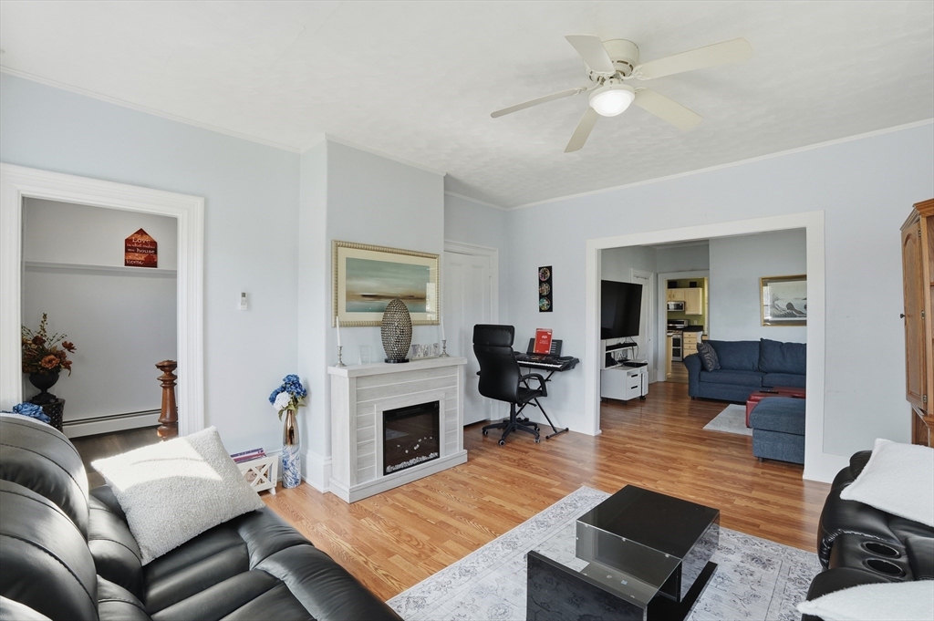 59 Cottage Street Franklin, MA 02038 - Photo 8 of 42 a living room with furniture and a fireplace