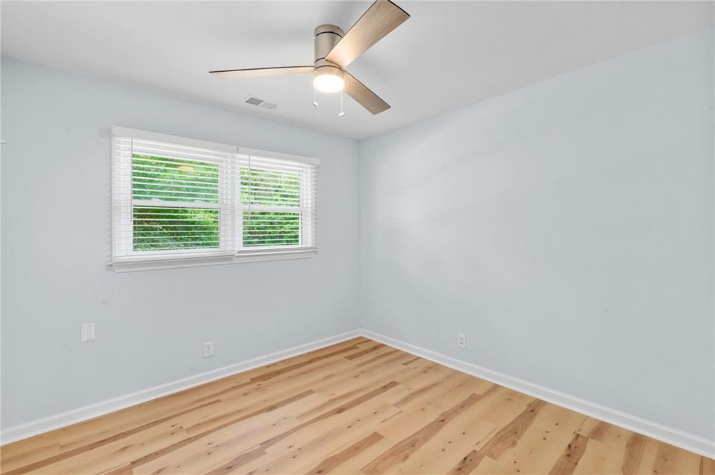 1745 Rockbridge Road Northwest Conyers, GA 30012 - Photo 15 of 32 wooden floor in an empty room with a window