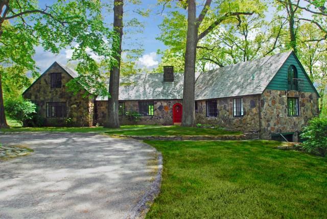 a view of a house with a yard and tree s