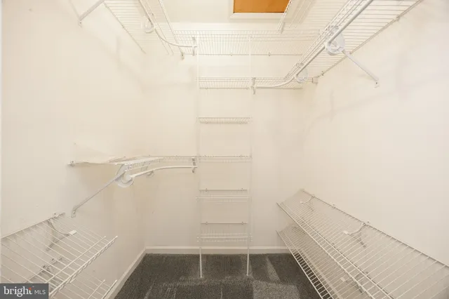 a bathroom with a shower a mirror a toilet and a sink