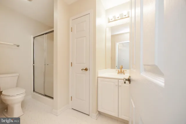 a bathroom with a toilet a sink and shower