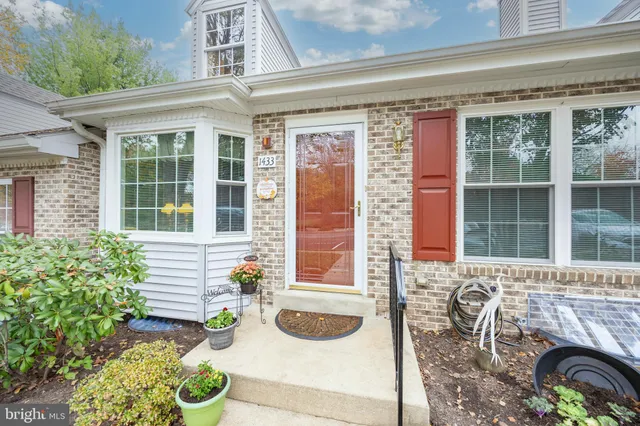 a front view of a house with outdoor seating