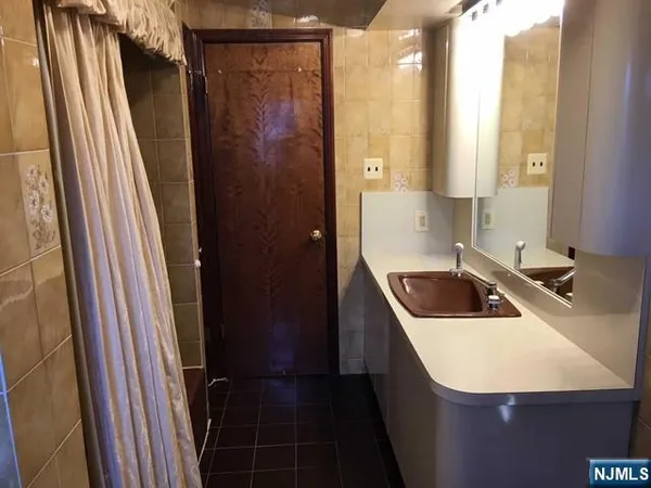 a bathroom with a sink a toilet a mirror and shower