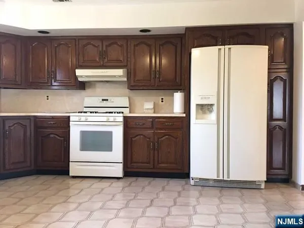 a kitchen with a stove and a refrigerator