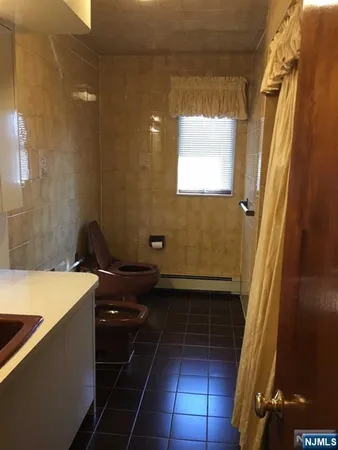 a bathroom with a sink a toilet and a shower