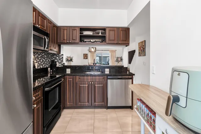 a living room with furniture and potted plant