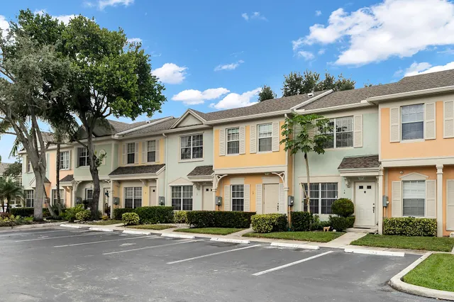 a front view of a residential houses with yard