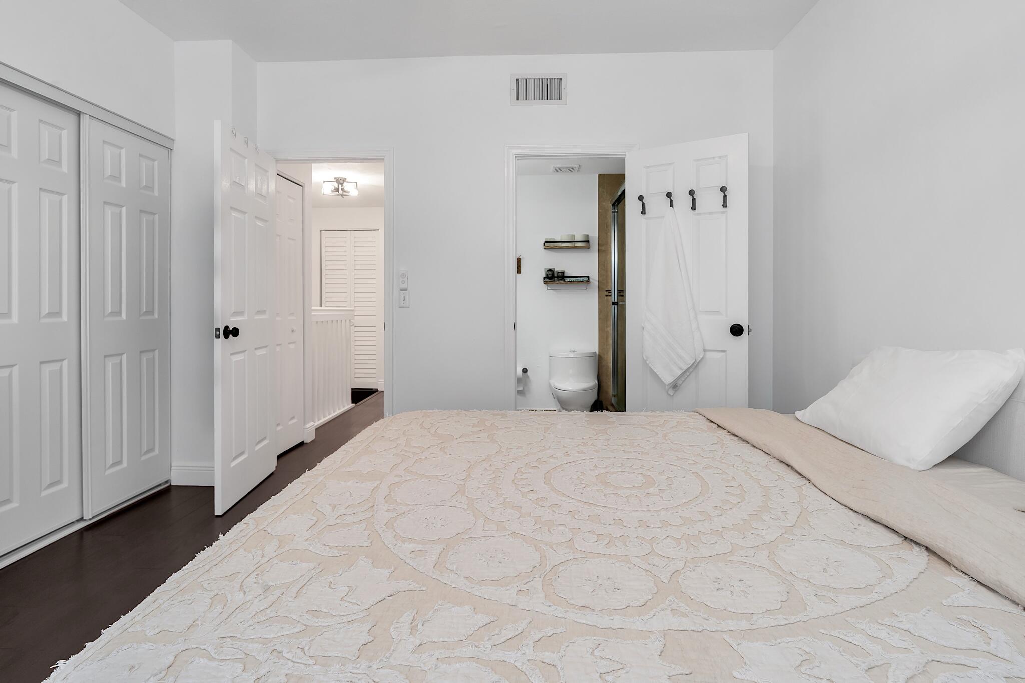 12 Fleming Court Weston, FL 33326 - Photo 36 of 51 a bedroom with a bed and a mirror