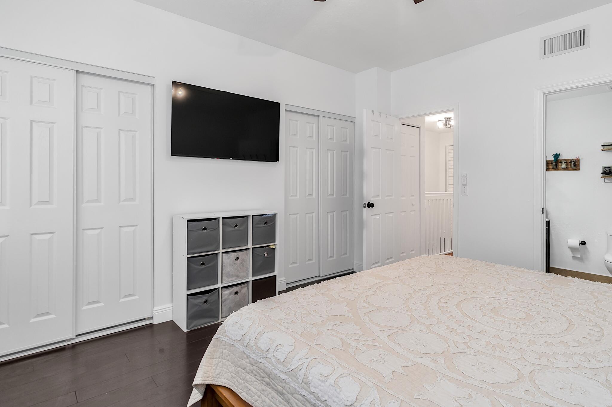 12 Fleming Court Weston, FL 33326 - Photo 37 of 51 a bedroom with a bed and a flat screen tv