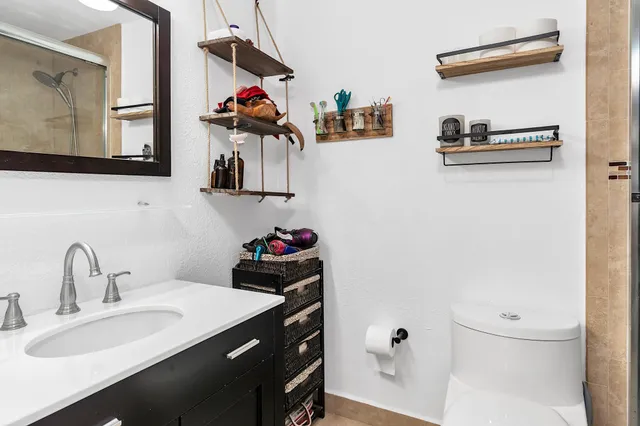 a bathroom with a granite countertop shower and a sink
