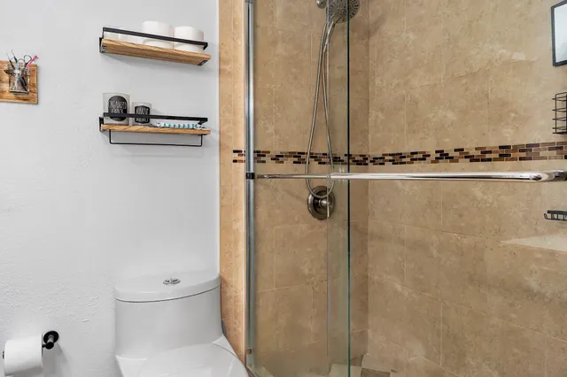 a bedroom with a large bed and tv