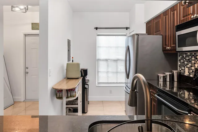 a kitchen with granite countertop a stove and a wooden floor