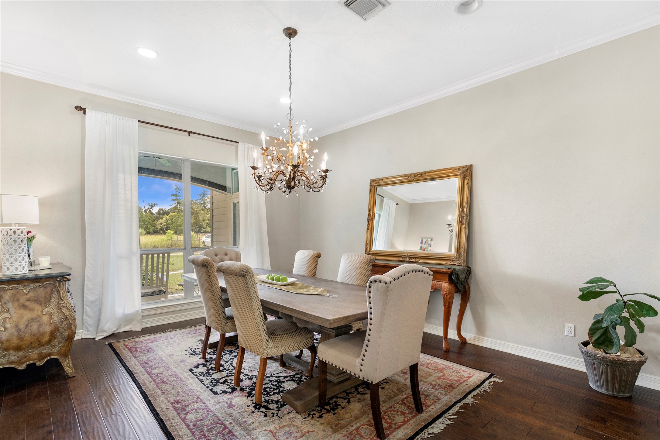 6530 Treaschwig Road, Unit 1 Spring, TX 77373 - Photo 6 of 32 a view of a dining room with furniture wooden floor and a chandelier