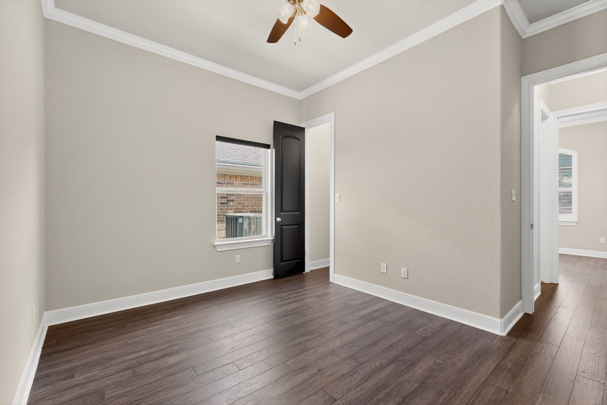 2617 Milan Meadows Drive Leander, TX 78641 - Photo 25 of 40 Hardwood floors and a well-placed window define this inviting bedroom space.
