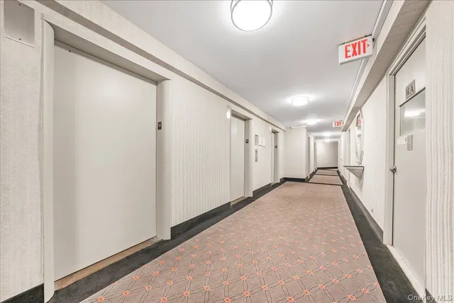 a view of hallway with stairs and furniture