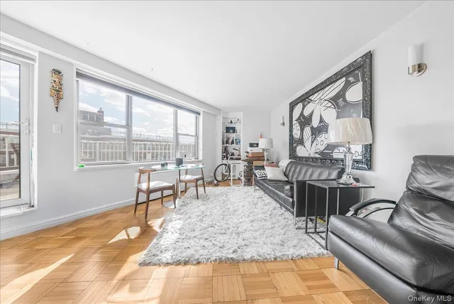a dining room with furniture and a large window