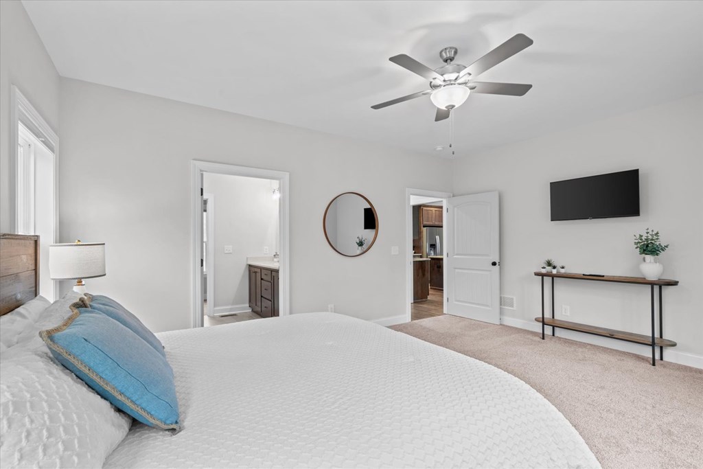 1068 High River Road Ellijay, GA 30540 - Photo 29 of 59 a bedroom with a large bed and a chandelier