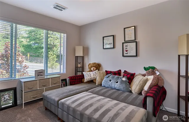 a spacious bedroom with a bed and a couch