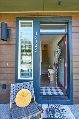 a living room with furniture and a potted plant