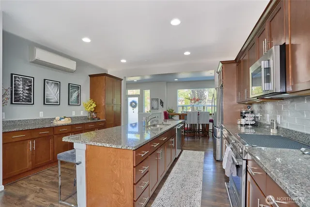 a large kitchen with granite countertop lots of counter space and sink