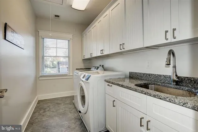 a spacious bathroom with a granite countertop sink and a mirror