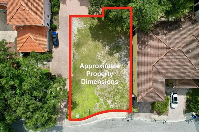 an aerial view of a brick house with a yard and potted plants