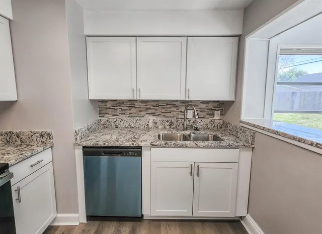 a kitchen with granite countertop cabinets and sink
