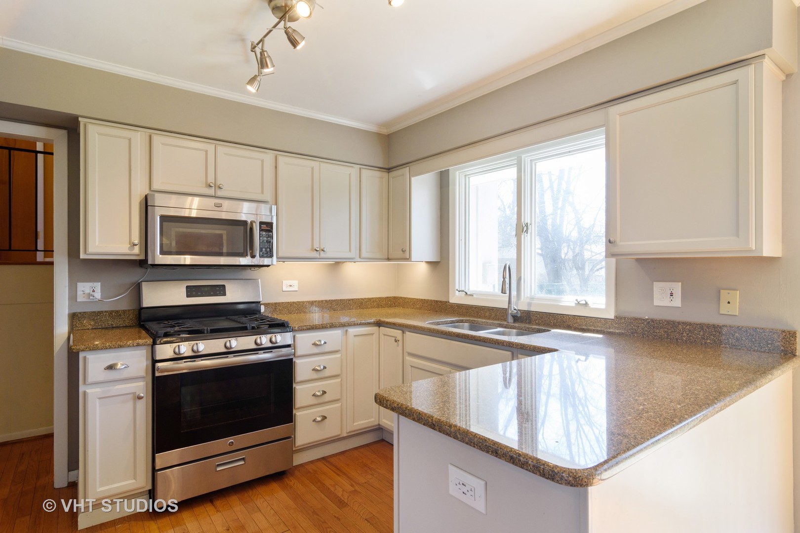 49 Miller Road Lake Zurich, IL 60047 - Photo 6 of 19 a kitchen with granite countertop a stove a sink and a microwave