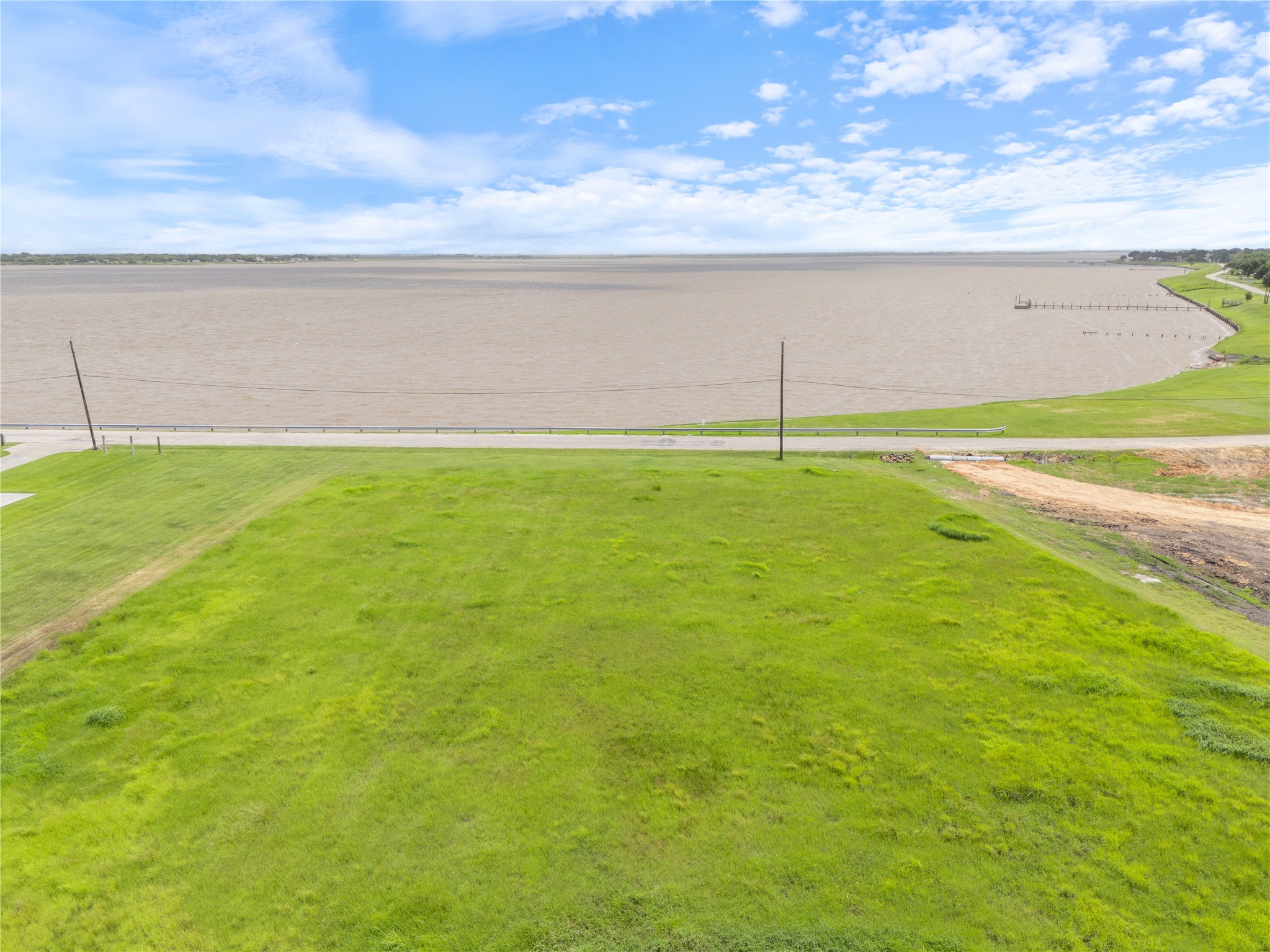 305 Bayshore Road Palacios, TX 77465 - Photo 10 of 25 A verdant parcel offers direct waterfront access for building your dream lakeside retreat.
