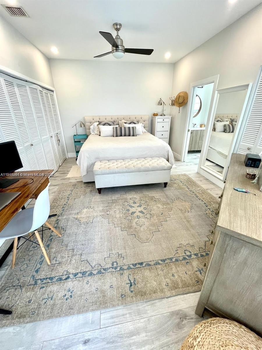 3070 Allamanda Street, Unit J Miami, FL 33133 - Photo 11 of 22 a bedroom with a bed and wooden floor